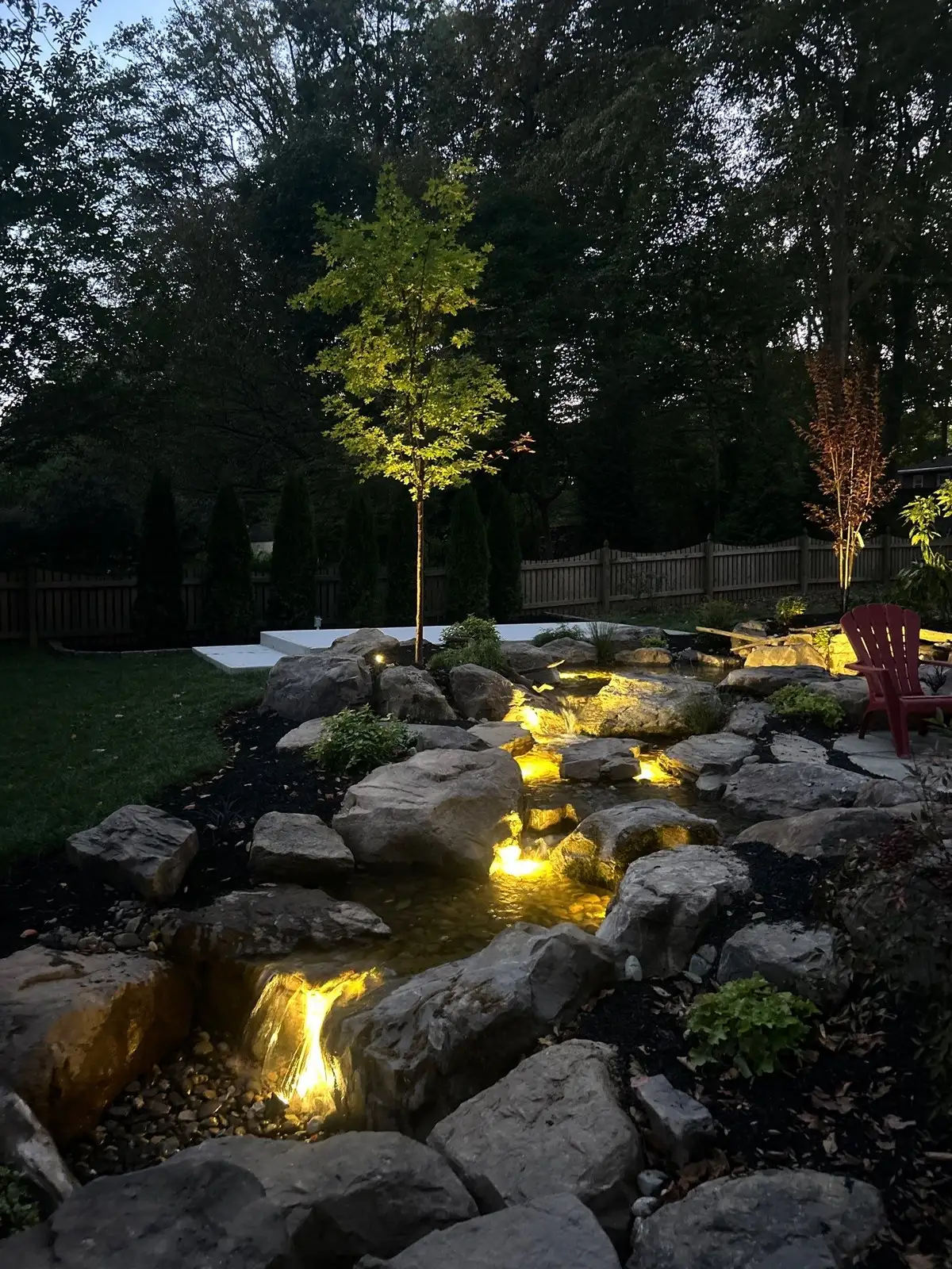 Pondless waterfall with natural stone landscaping
