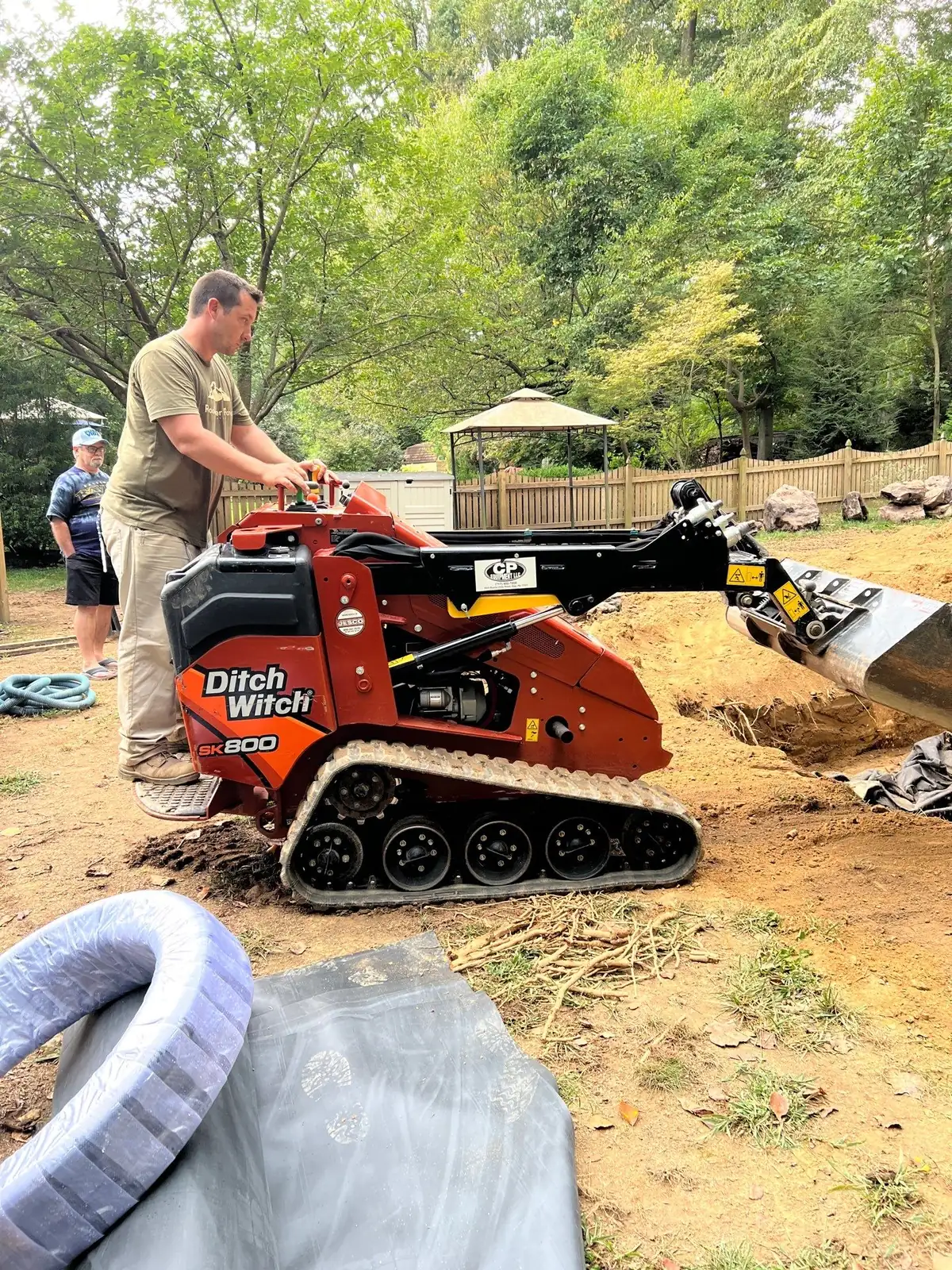 Excavation and liner installation for koi pond construction