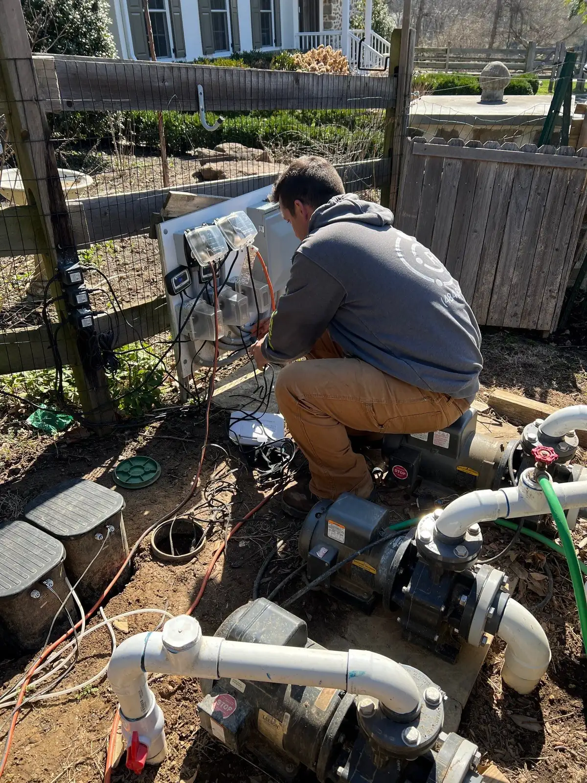 Pond technician testing water quality during routine maintenance visit