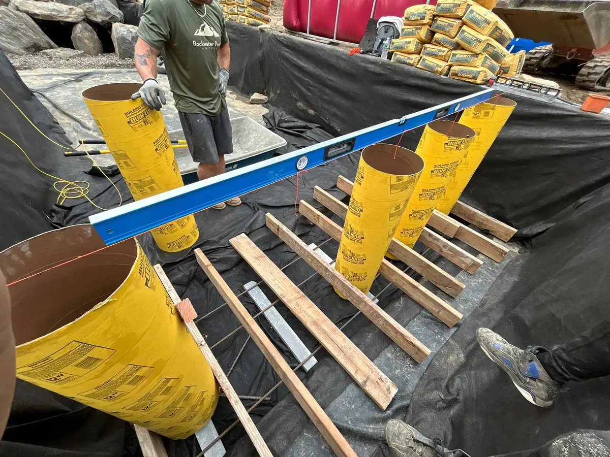 Rock Water Ponds crew member performing routine pond maintenance