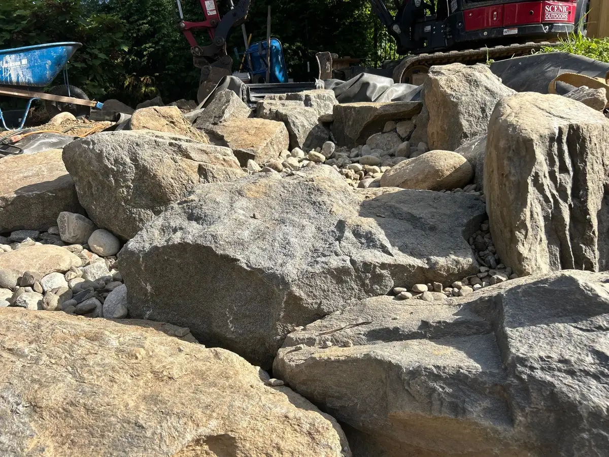 Rock Water Ponds technician performing filter maintenance on koi pond