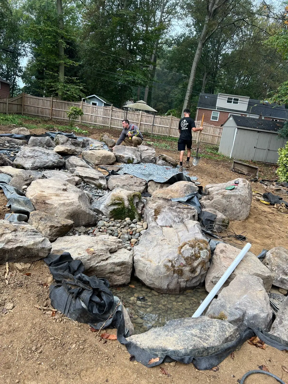 Rock Water Ponds founder and team at a water feature project site