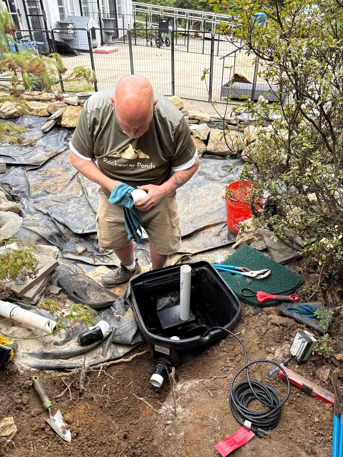 Rock Water Ponds crew working on a waterfall installation
